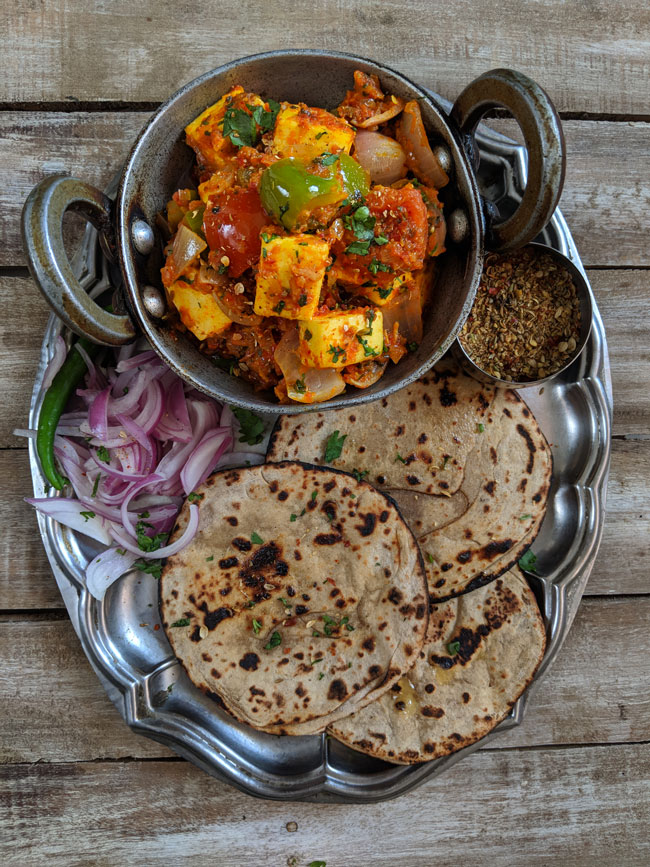 aerail shot of thali with kadhai paneer and tandoori roti