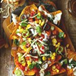 aerial shot of loaded veggies nachos on a platter