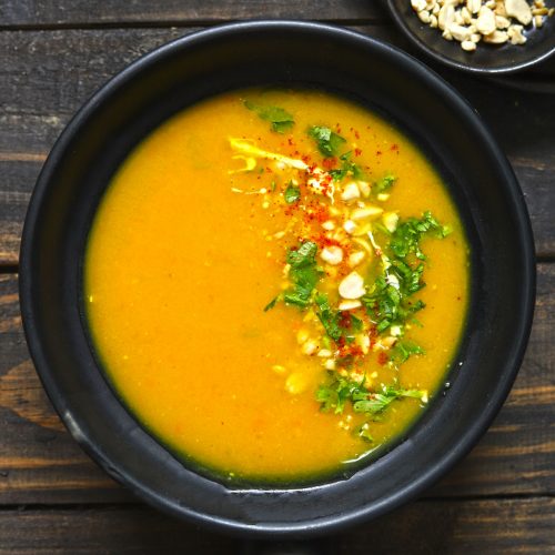 aerial shot of pumpkin soup in a black serving bowl