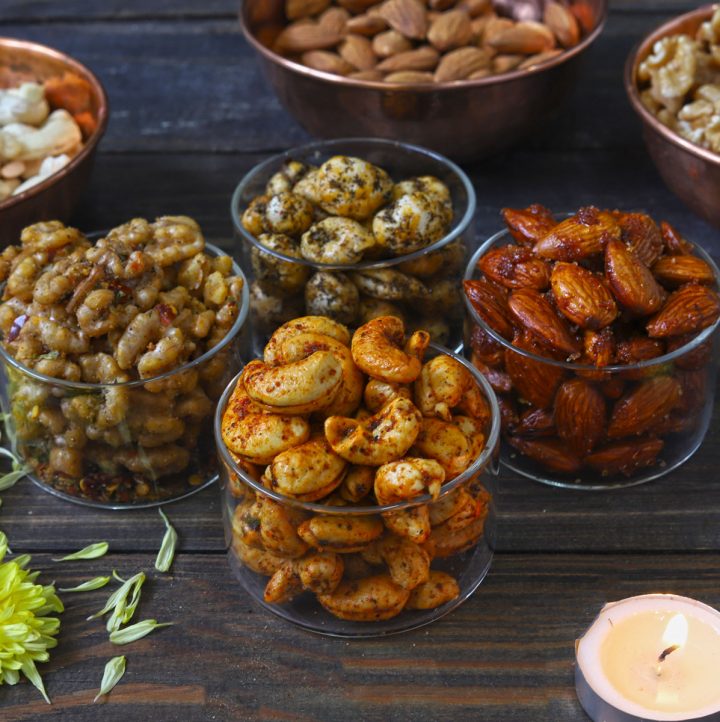 side close up shot of roasted nuts in glass bowls