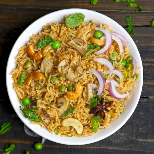 aerial shot of mushroom pulao in a white ceramic bowl