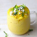 side shot of dhokla in a glass mug