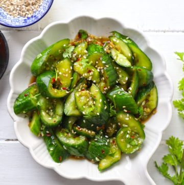 aerial shot of smashed cucumber salad on a white ceramic platter