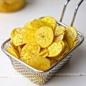 side shot of banana chips stacked on a wire basket