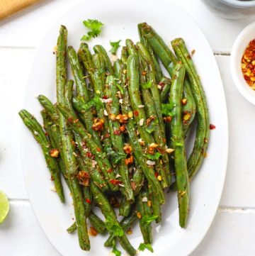 aerial shot of air fryer green beans on a white platter