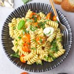 aerial shot of caprese pasta served on a black bowl