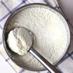 aerial shot of curd in a stainless steel conatiner.