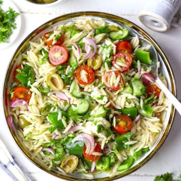 aerial shot of Greek orzo pasta salad in a white bowl