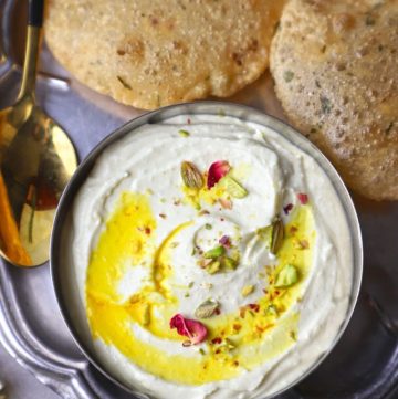 aerial shot of Shrikhand with poori in a platter