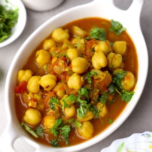 side close up shot of chana curry in a white ceramic bowl