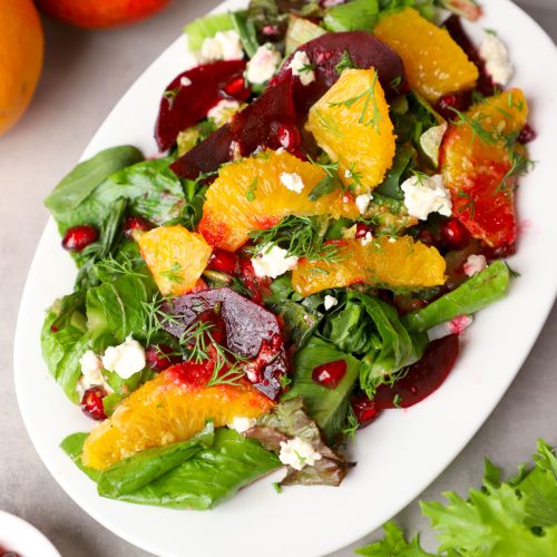 aerial shot of beetroot and orange salad served on a white platter