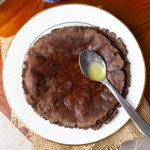 aerial shot of ragi roti with ghee on a plate