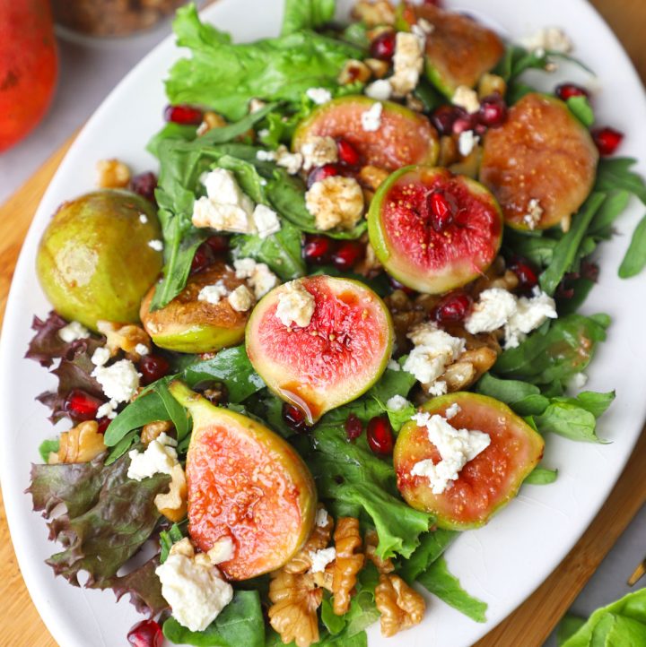 aerial close up shot of roasted fig salad on a white platter