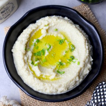 aerial shot of mashed cauliflower in a black bowl