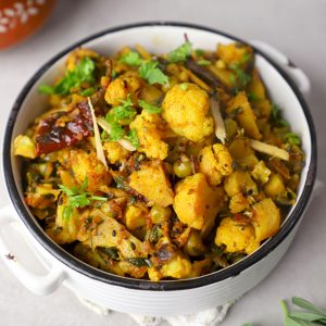 aerial close up shot of aloo gobi served in a white bowl