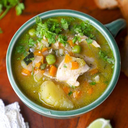 aerial shot of chicken stew in a green bowl