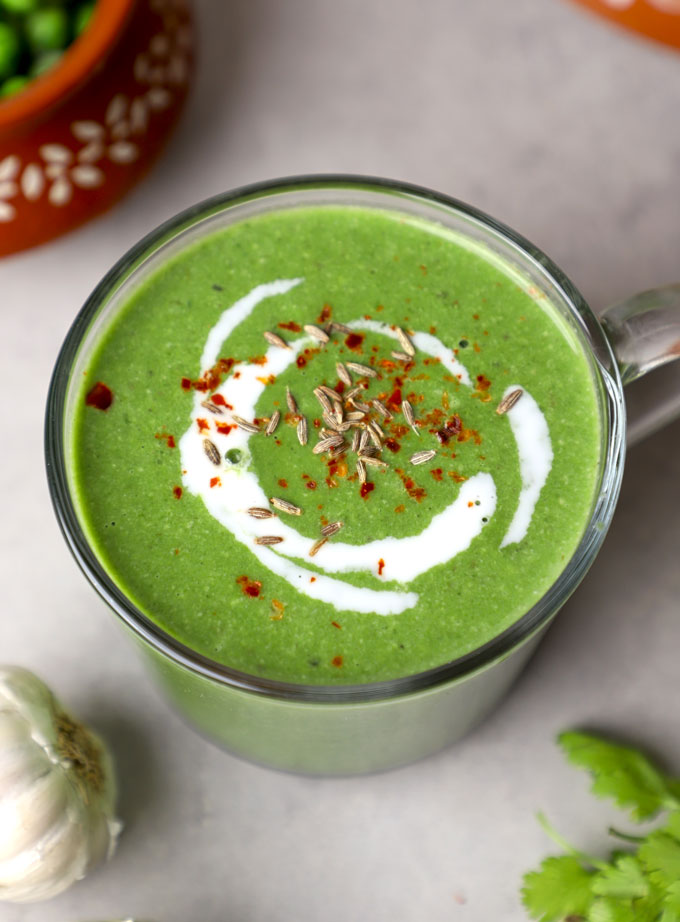 aerial side shot of vegan spinach soup in a mug.