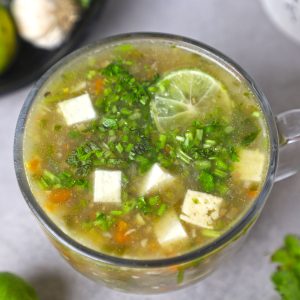 aerial close up shot of lemon coriander soup in a mug