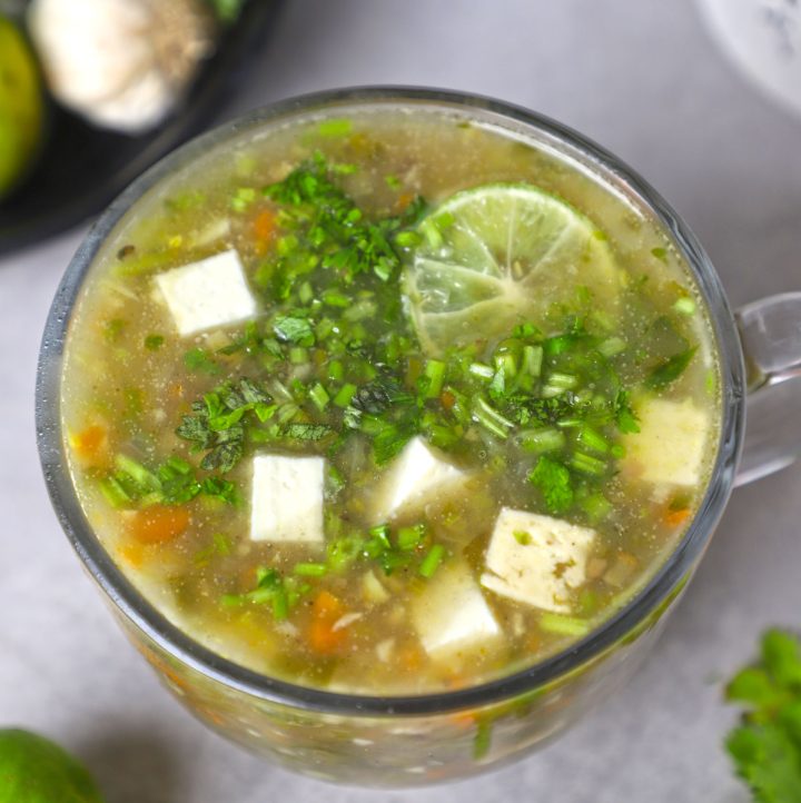 aerial close up shot of lemon coriander soup in a mug