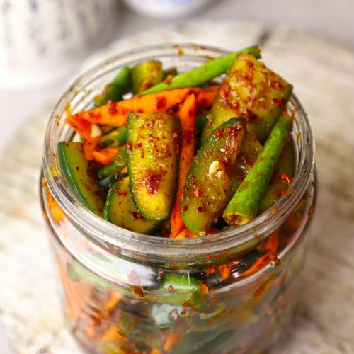 close up shot of cucumber kimchi in a jar